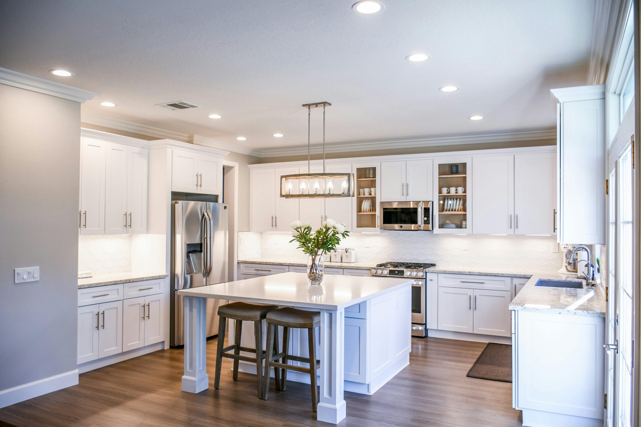 Beautifully updated kitchen showcasing home projects that will add value with modern countertops, stylish lighting, and energy-efficient appliances